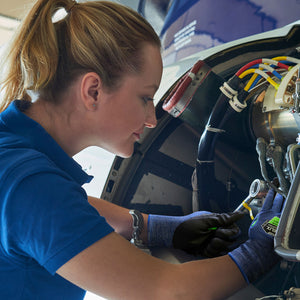 woman working on a machine pump wearing Helix® 3026