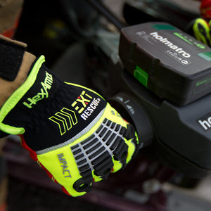 firefighter wearing EXT Rescue® 4014 using a rescue tool