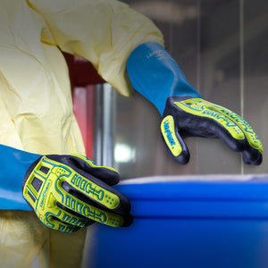 worker with a plastic drum wearing HexChem® 7071