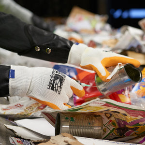 worker wearing SharpsMaster II 9014 picking through trash and holding sharp objects