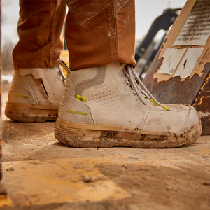Construction worker standing in Xtend women's safety boots on a step.