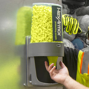 two workers next to Turn2® refillable earplug dispenser getting earplugs