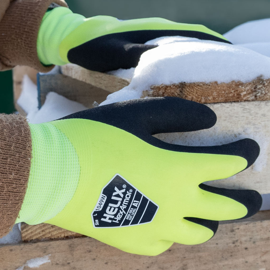 worker holding a wood pallet in the winter wearing Helix® 1049W