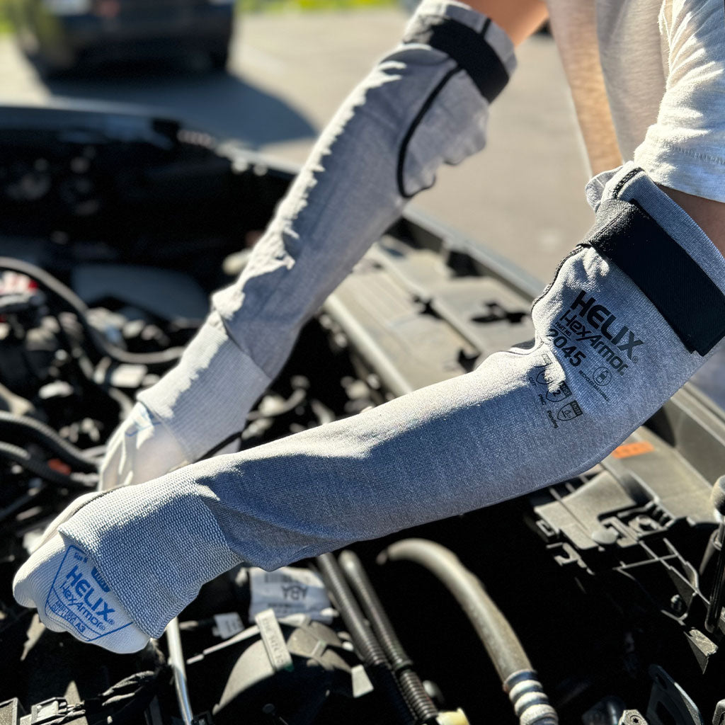 mechanic working on a car wearing Helix® 2045 cut resistant arm sleeve