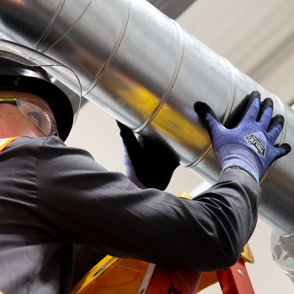 working holding a vent wearing Helix® 2074