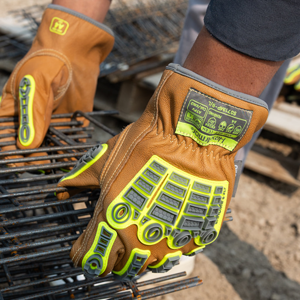 Hands wearing chrome slt 5071imp impact leather gloves with water and oil resistant sustainable leather treatment.