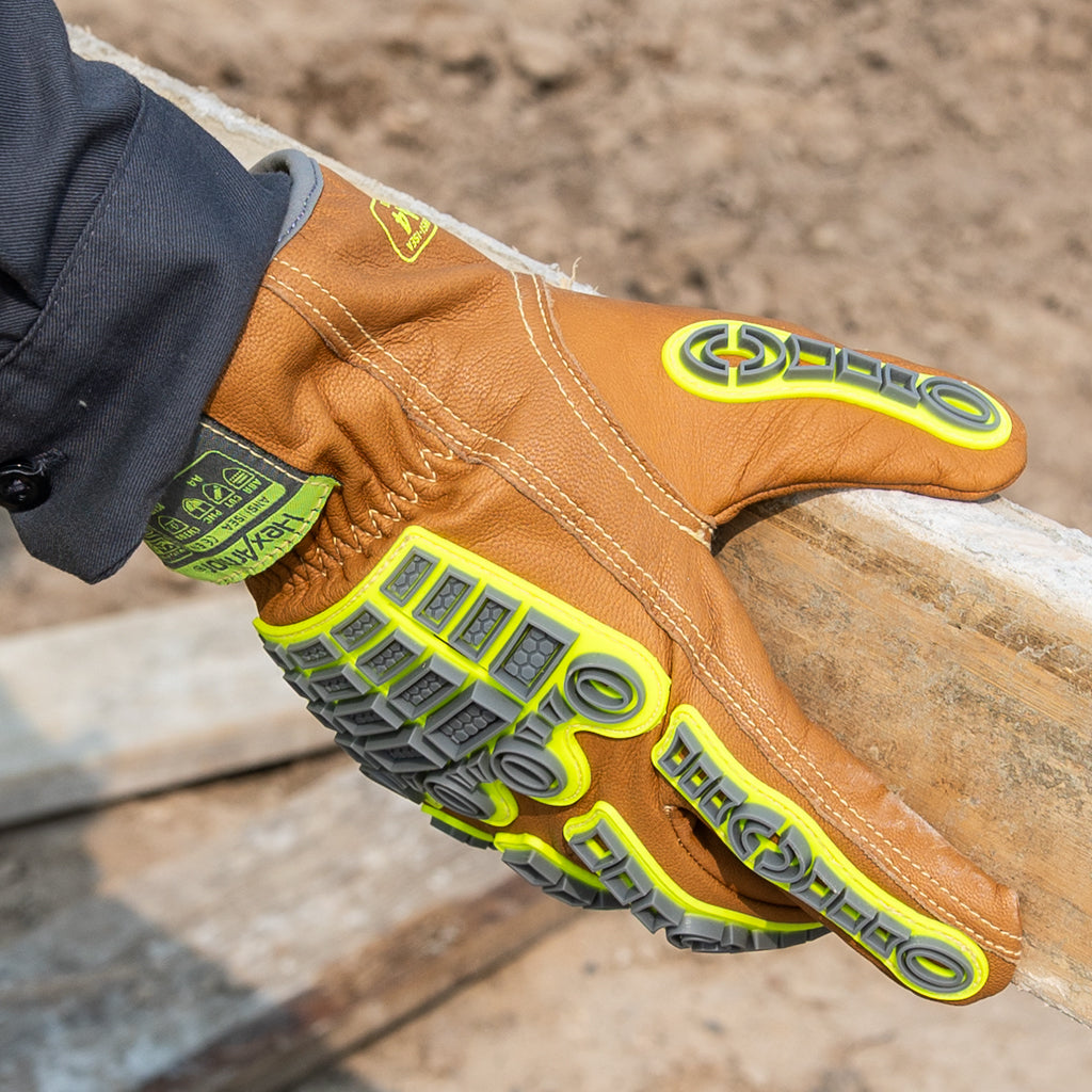 Hands wearing chrome slt 5072imp impact leather gloves with water and oil resistant sustainable leather treatment.