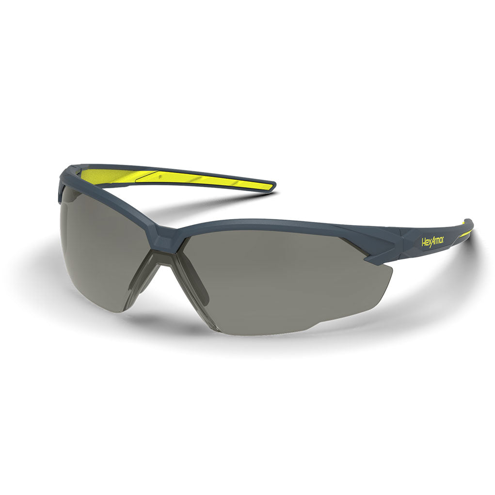 Grey and yellow NX1 anti-fog safety glasses shown as they are sitting on a table.