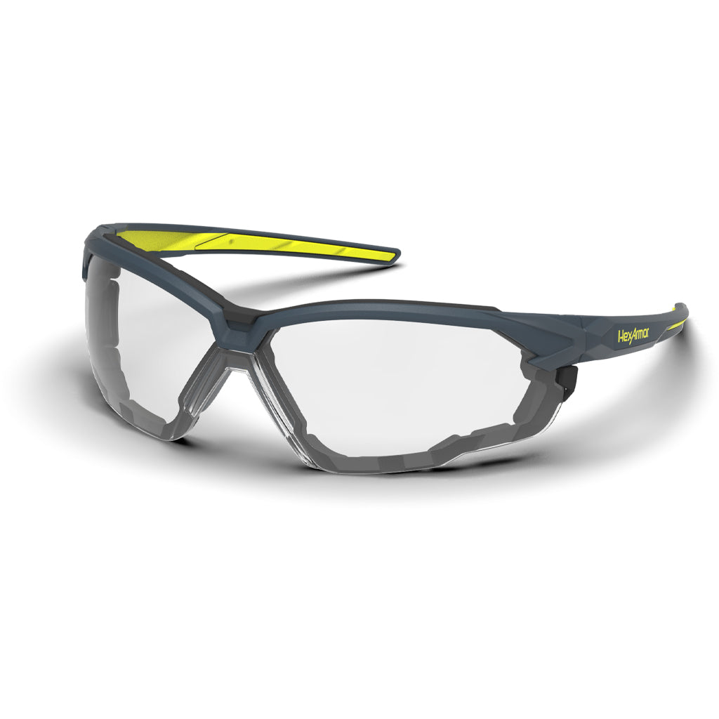 Grey and yellow NX1G anti-fog gasketed safety glasses shown as they are sitting on a table.