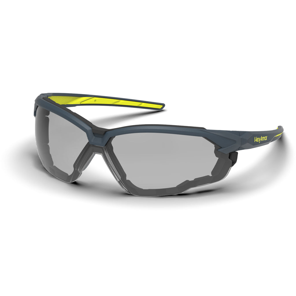 Grey and yellow NX1G anti-fog gasketed safety glasses shown as they are sitting on a table.