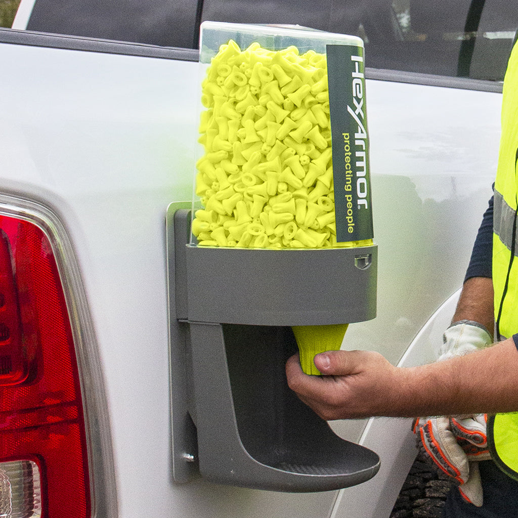 Turn2® refillable earplug dispenser attached to truck and worker getting earplugs