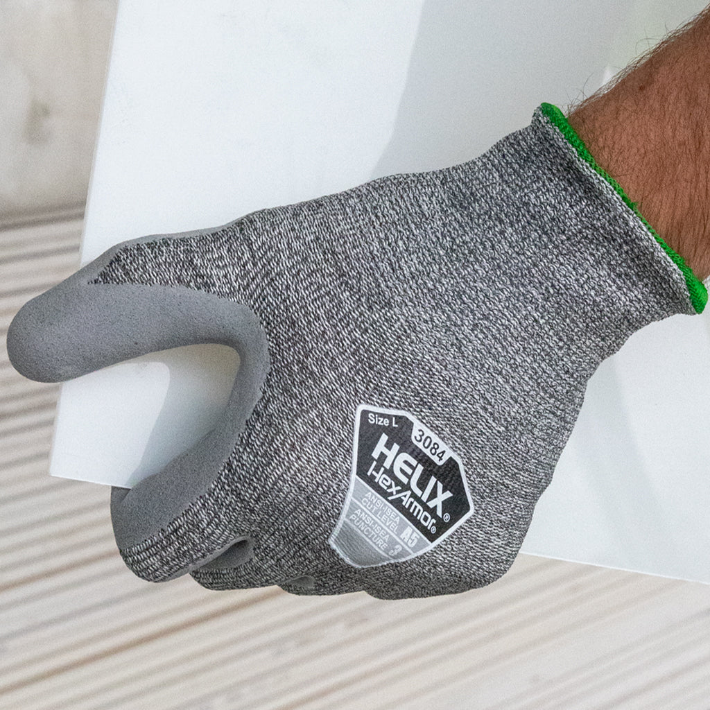 worker holding a white panel wearing Helix® 3084